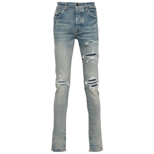 FLEX SHOP Amiri clay indigo distressed jeans with whiskering, front rips, and contrast underlay detailing.