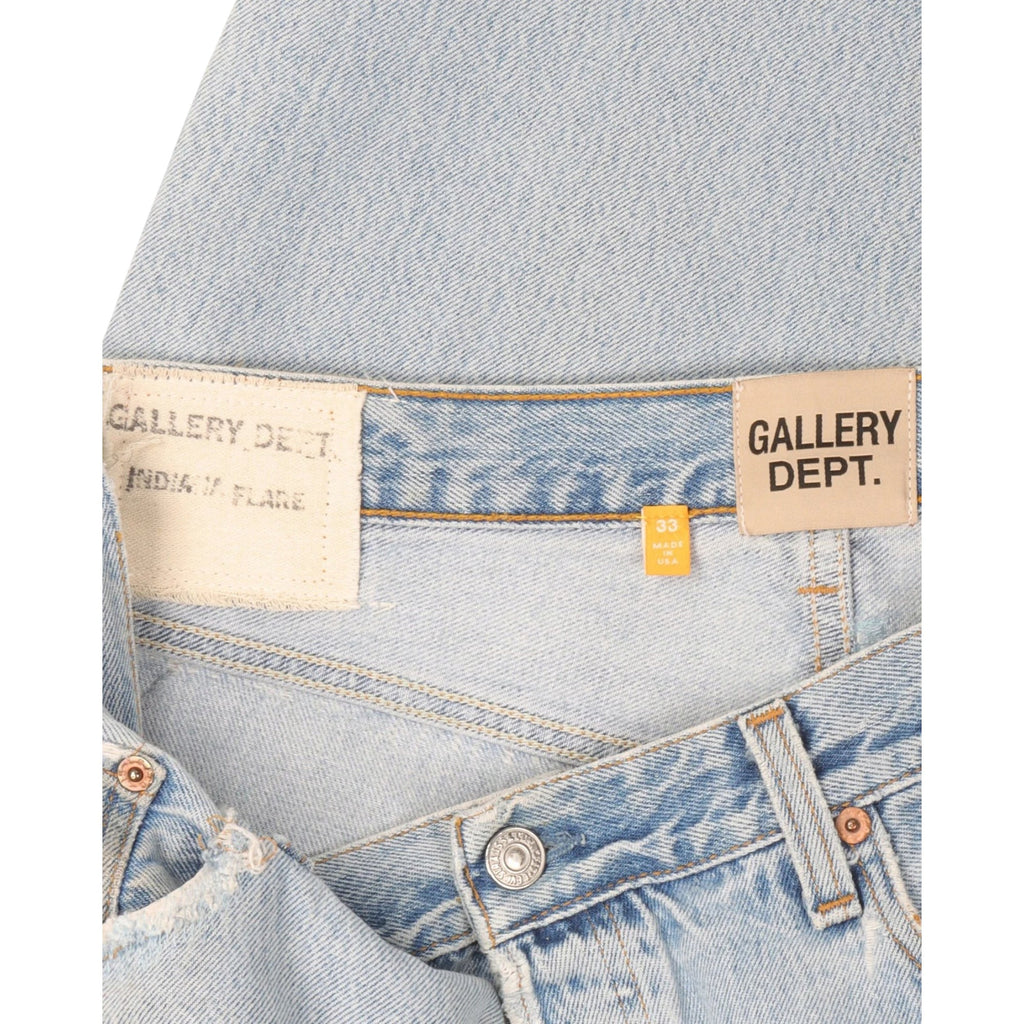 FLEX SHOP Gallery Dept. light blue distressed denim jeans with branded waist labels and vintage flare detailing.