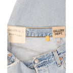 FLEX SHOP Gallery Dept. light blue distressed denim jeans with branded waist labels and vintage flare detailing.