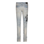 FLEX SHOP Amiri Wes Lang Reaper jeans in clay indigo blue denim with black graphic print, back view.