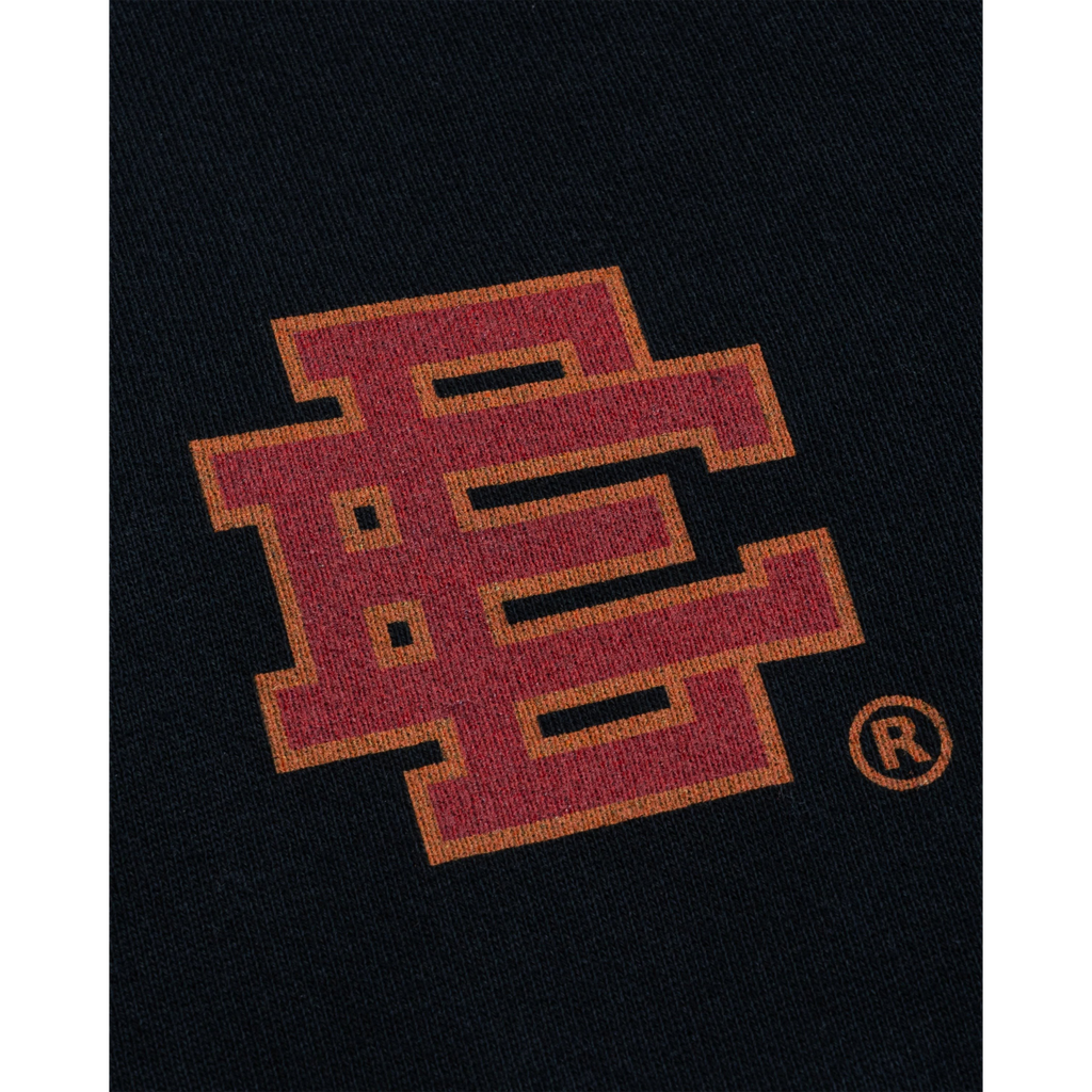 FLEX SHOP Eric Emanuel black sweatpants featuring a red and orange flame-patterned EE logo detail