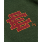 FLEX SHOP Eric Emanuel green hoodie featuring a red and orange flame-patterned EE logo embroidery on the chest.