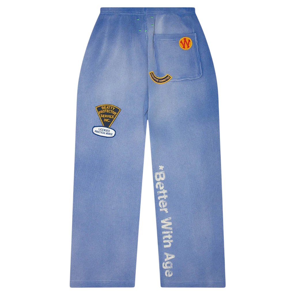 FLEX SHOP blue waffle-knit sweatpants featuring vintage-style patches and Better With Age text detail.