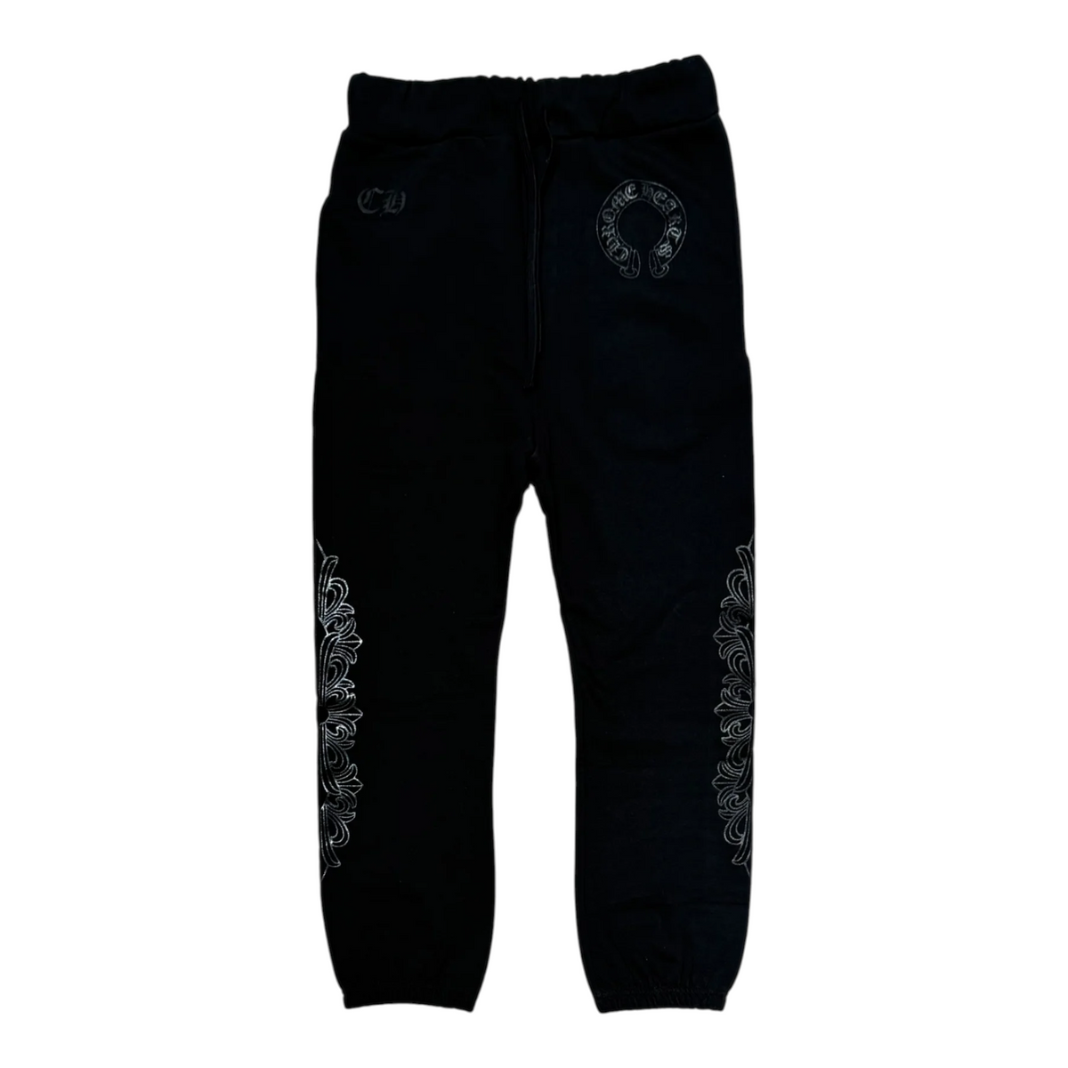 FLEX SHOP black sweatpants featuring white horseshoe and floral cross graphic prints on the legs and hip.