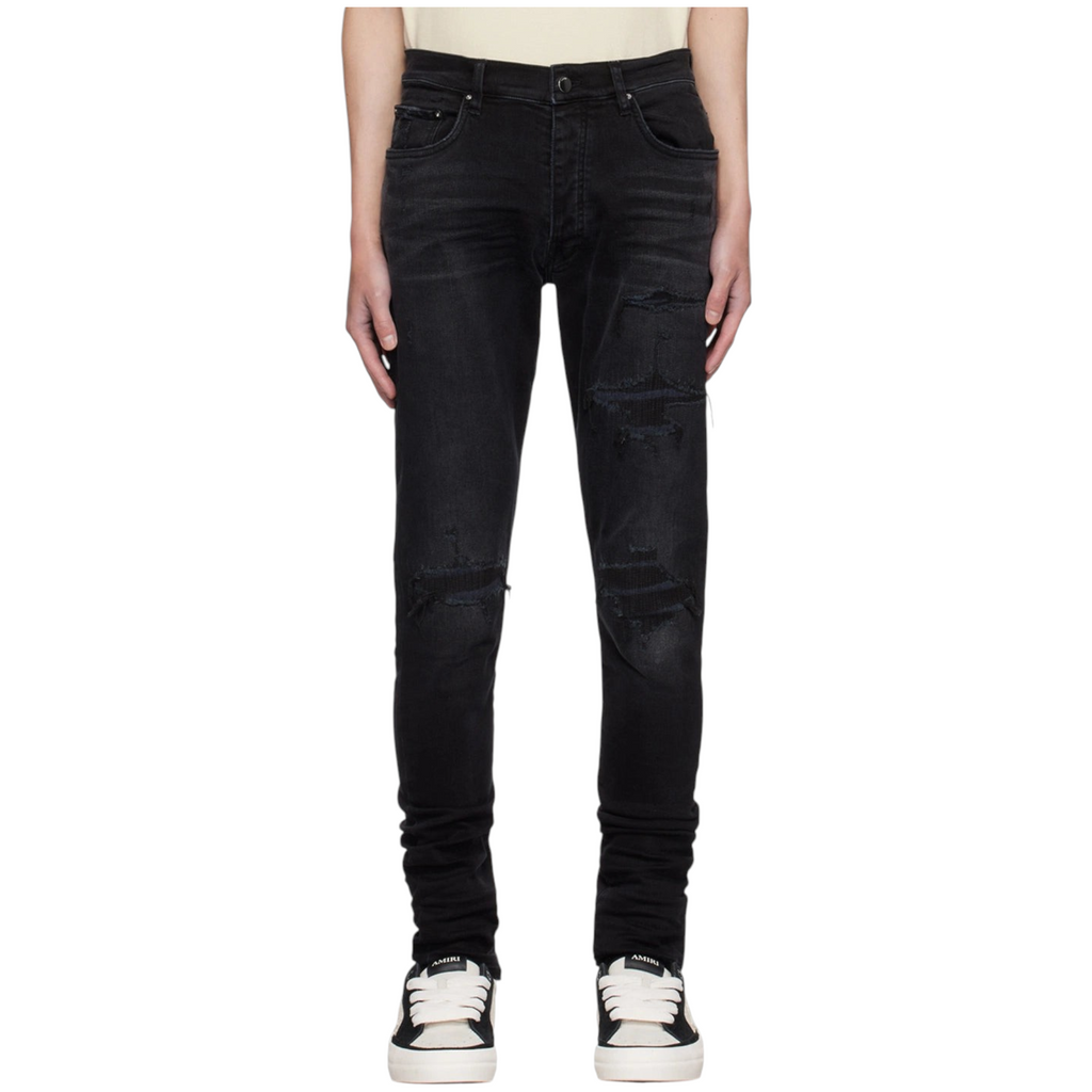 FLEX SHOP Amiri vintage black distressed denim jeans with ripped knees and embroidered varsity repair details