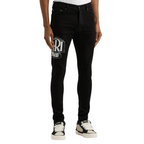 FLEX SHOP Amiri black skinny jeans with crystal Hollywood logo, distressed denim, and tapered fit on a male model.